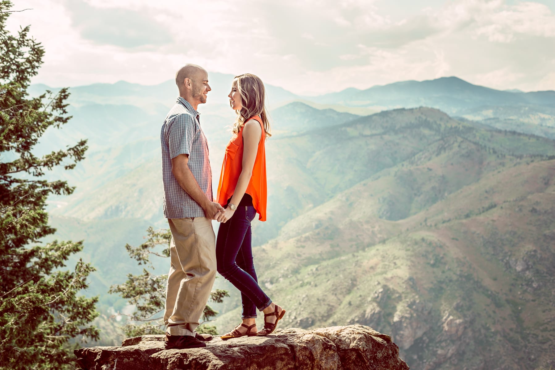 Couple enjoying a romantic moment together in a scenic Colorado mountain setting at golden hour