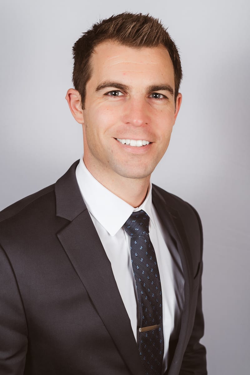 Professional business portrait showing confident expression and polished appearance