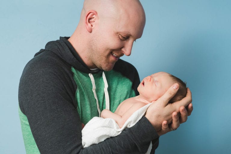 Tender newborn moment captured by Denver baby photographer From the Hip Photo
