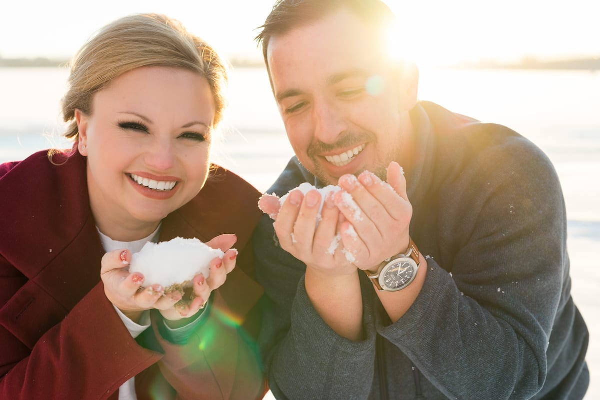 cherry creek state park engagement photos, a couple blowing snow.