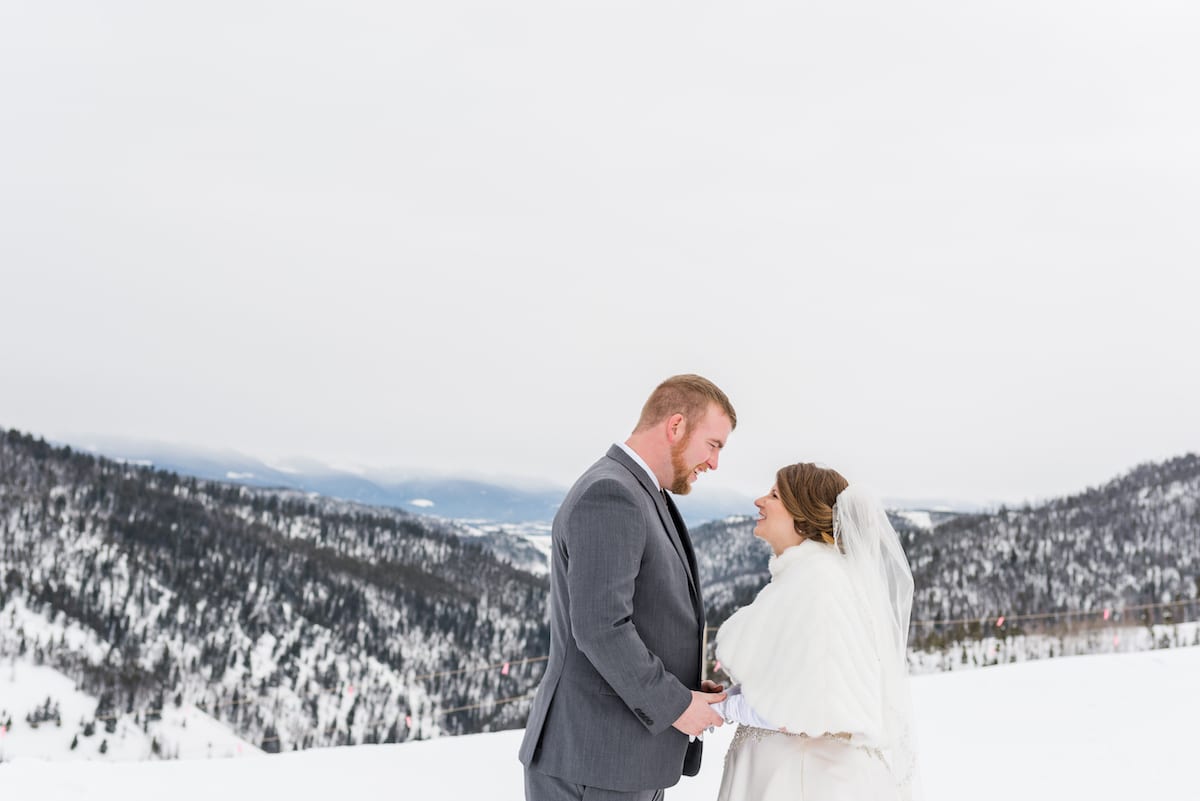 Bride and groom on winter mountain