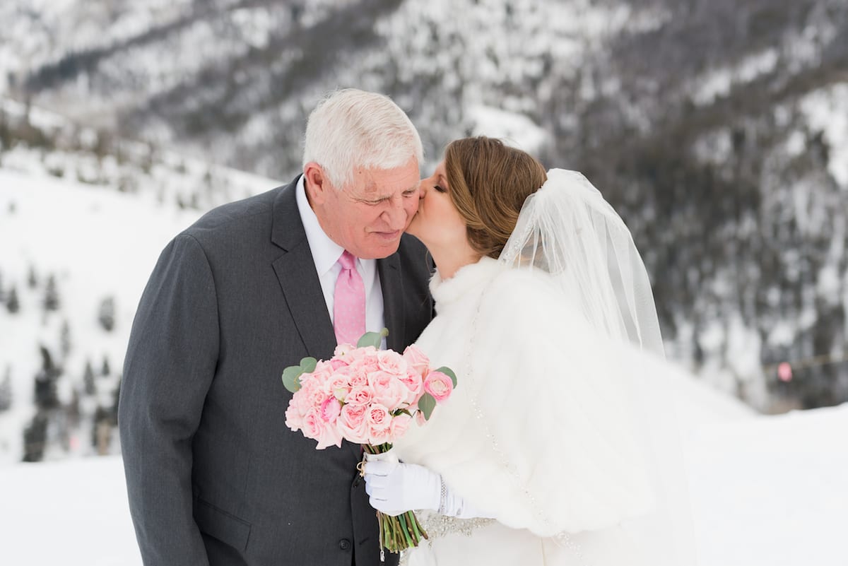 Bride kisses her father's cheek