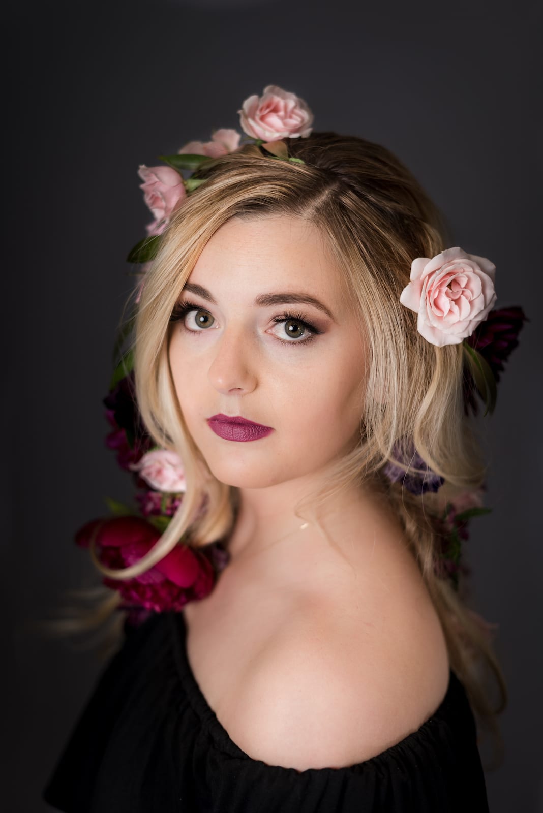 Professional headshot showing refined styling with natural makeup and polished hair