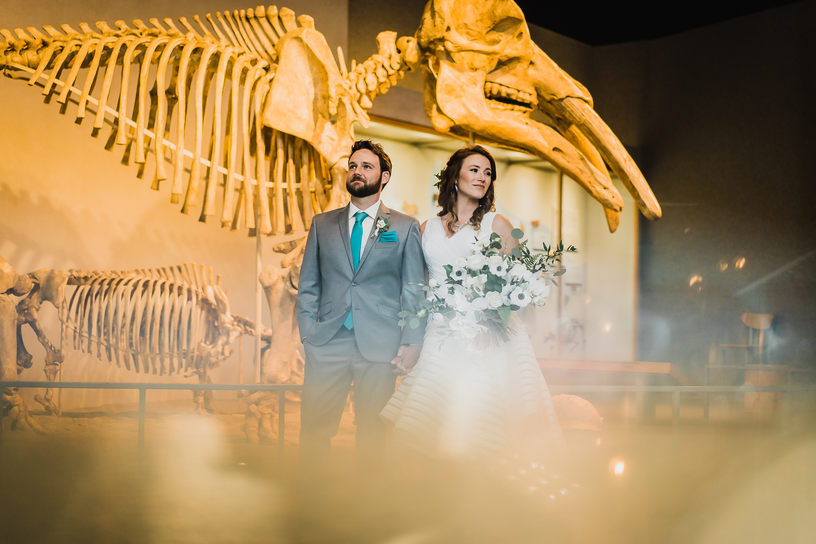 Bride and groom on museum terrace with mountain views behind them