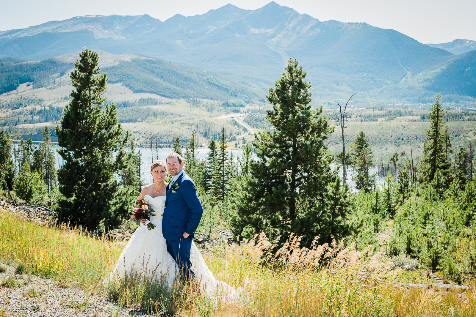 Mountain wedding in Frisco | Bride and groom arm in arm on mountain slope