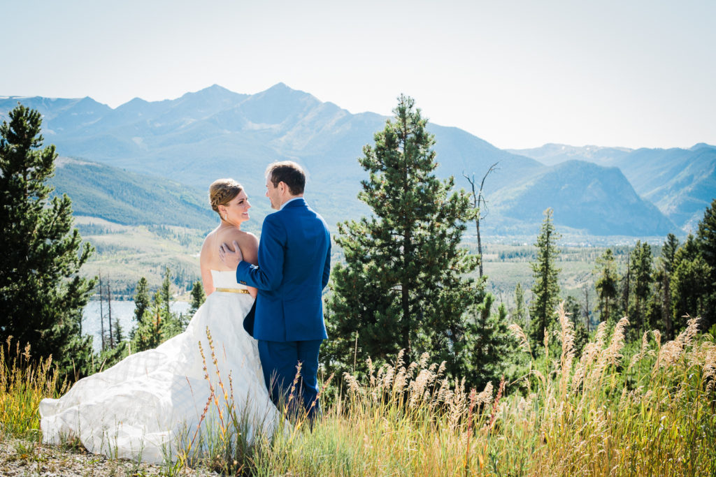 Mountain wedding in Frisco | Bride and groom look at each other lovingly as they stand in front of scenic mountain view