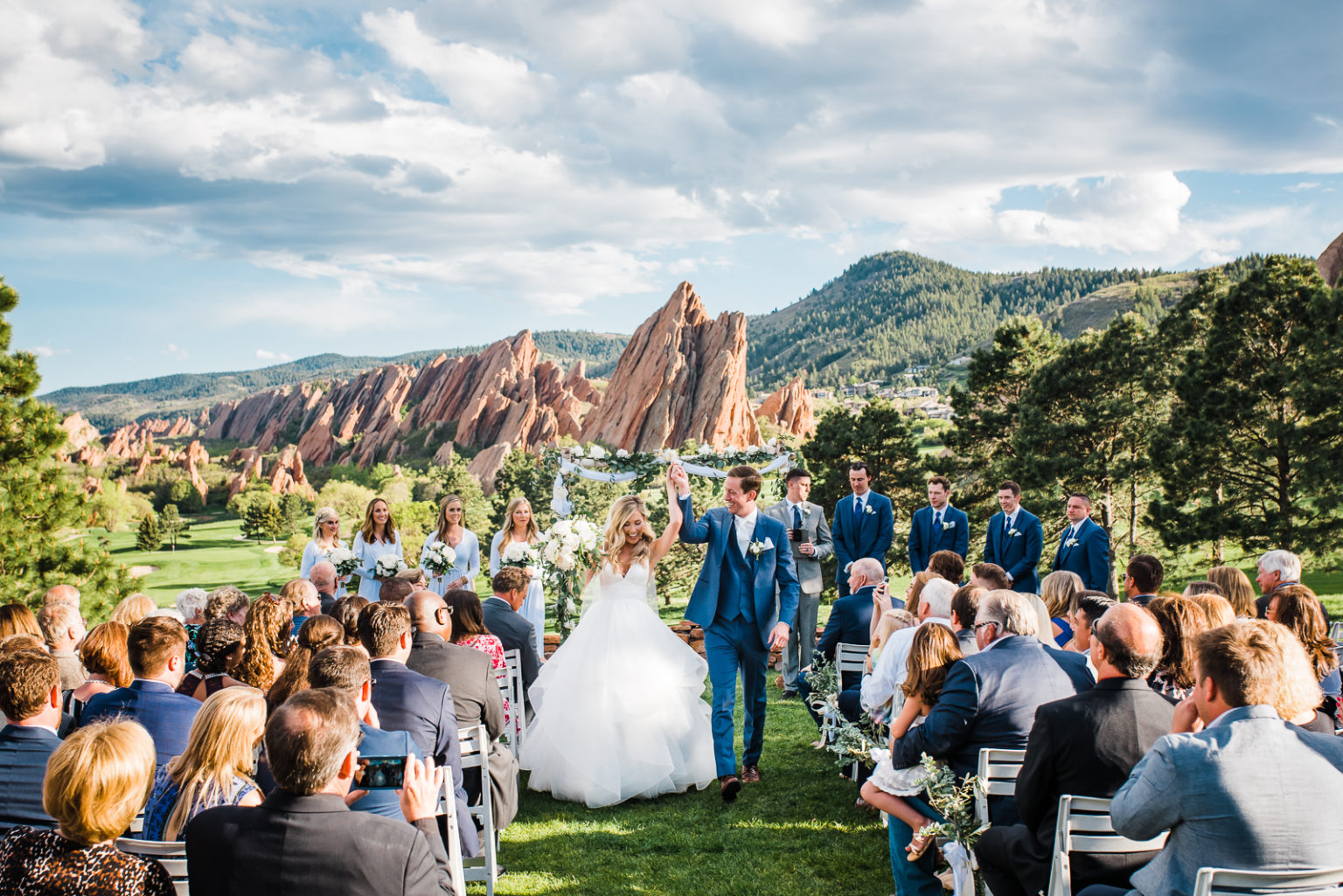 Wedding ceremony at Arrowhead Golf Club surrounded by red rock formations