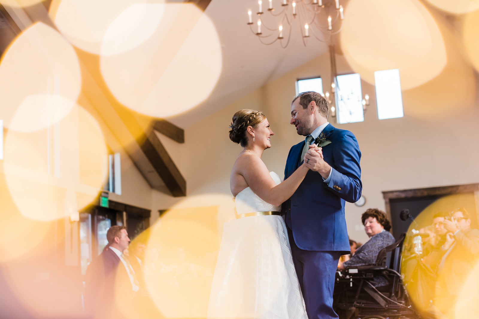 Bride and groom dance between shiny lights