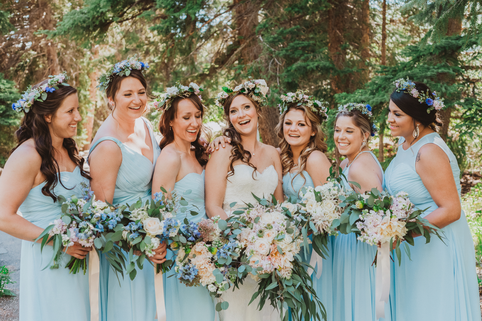 Couple embracing with snow-capped mountain peaks and aspen forests in background at Vail Colorado ski resort
