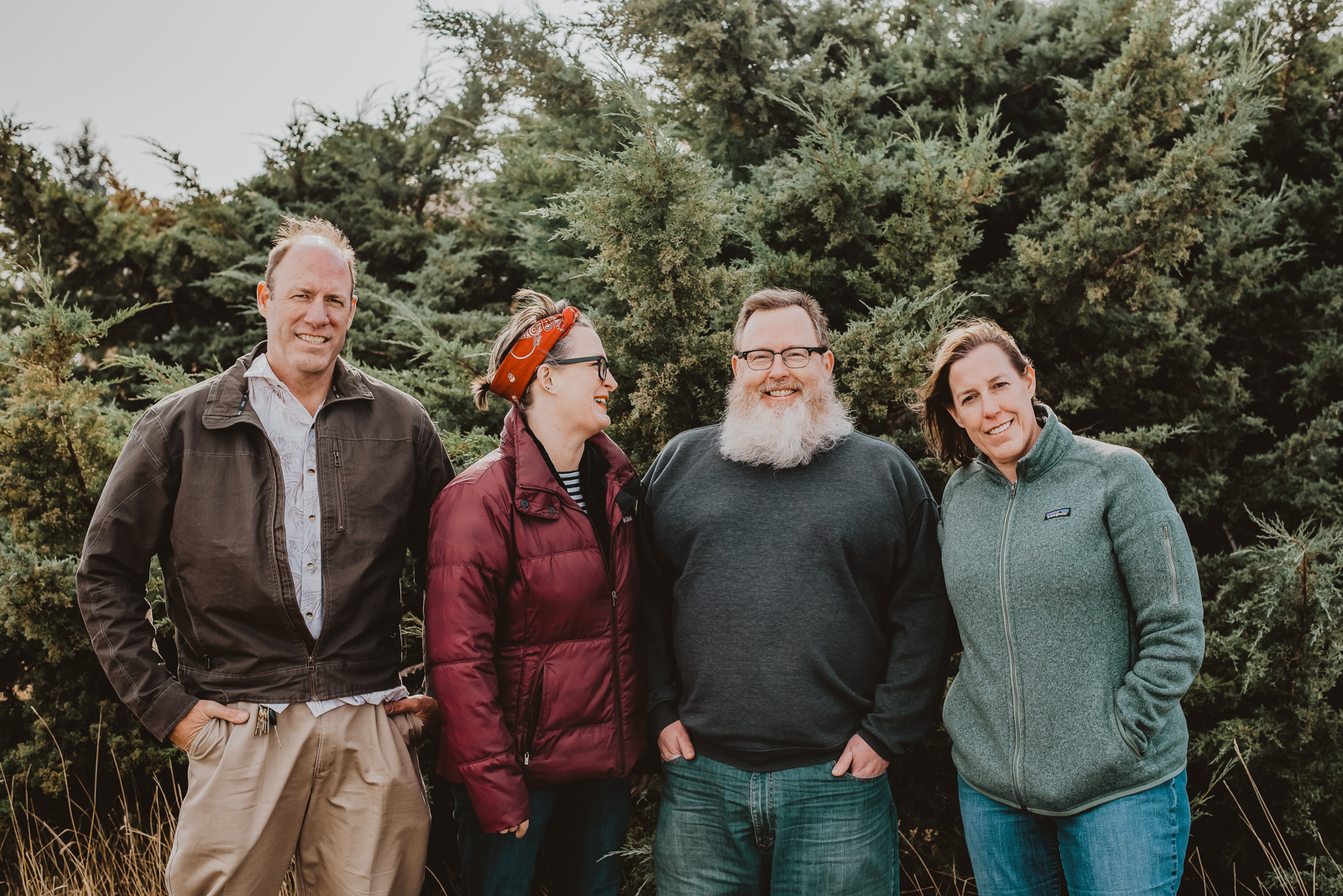 Family group portrait at Harper Lake with scenic water and mountain backdrop