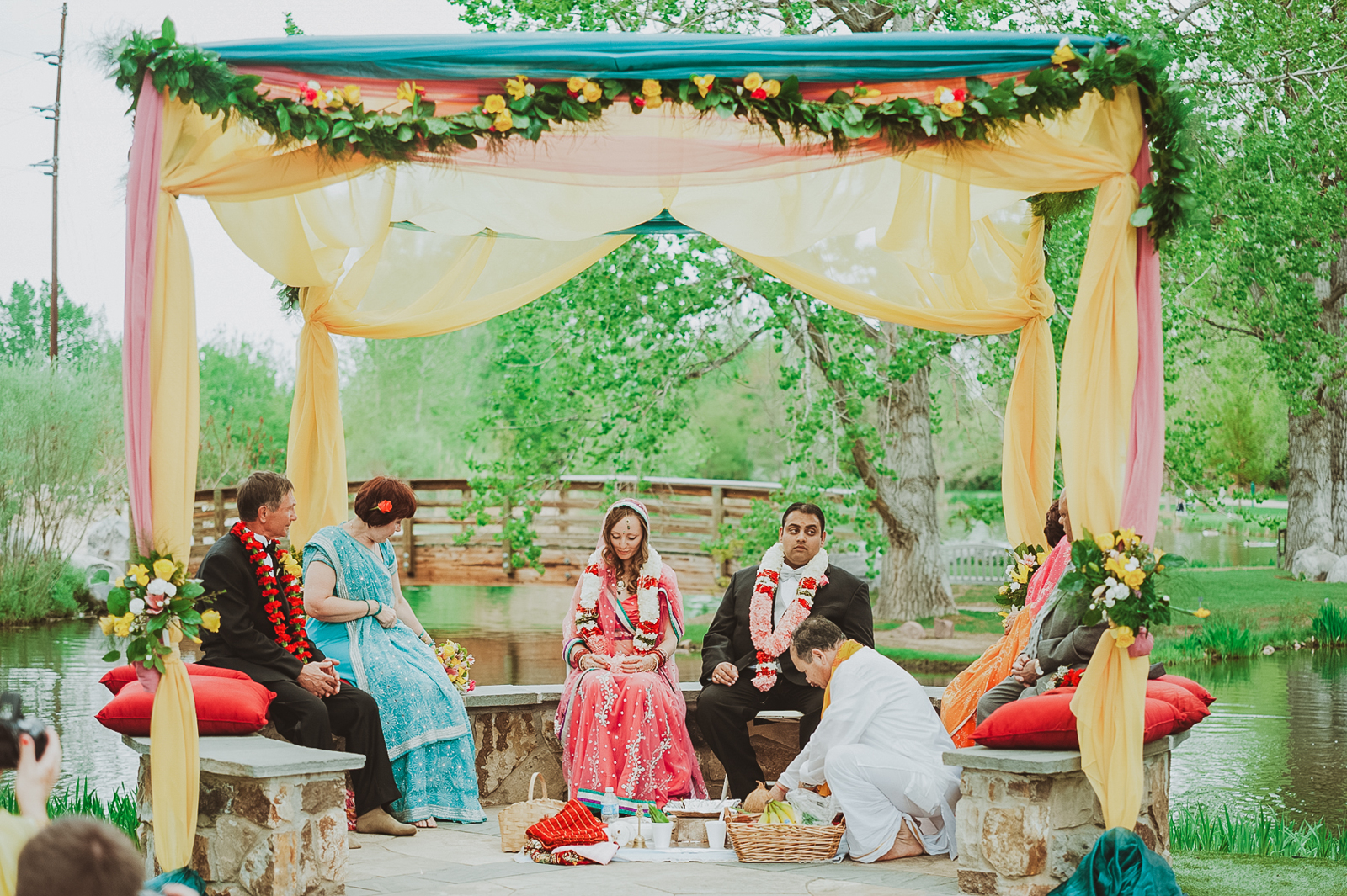 Bride and groom at altar in Hudson Gardens with cascading garden backdrop