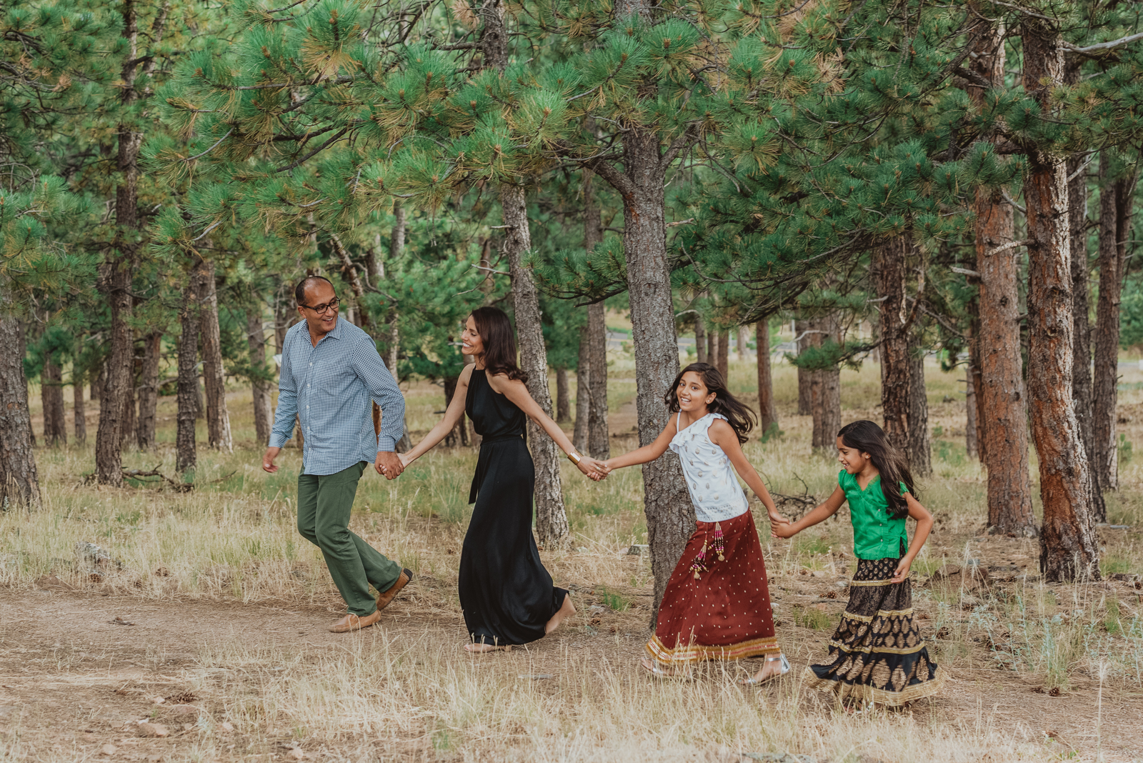 Family enjoying time together on grassy area at Lookout Mountain Golden Colorado during golden hour
