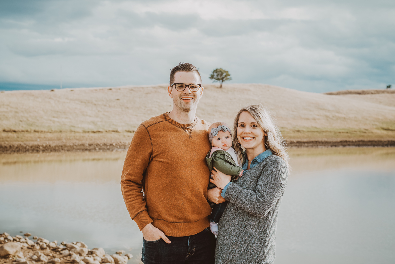 Candid family moment with natural poses against mountain landscape