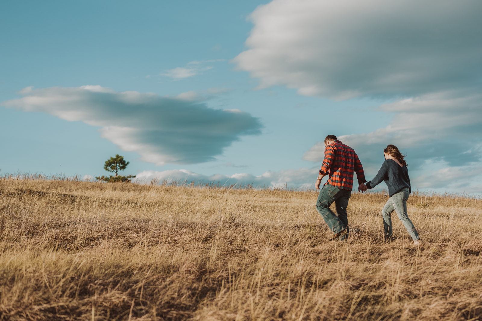 Couple kissing with panoramic mountain vista and wilderness setting