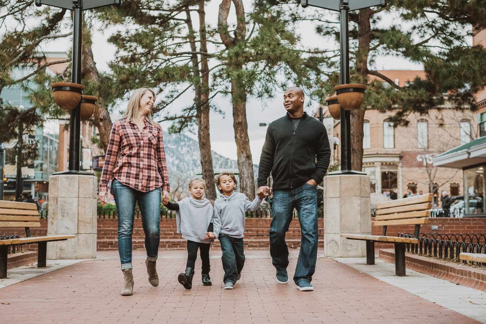 Outdoor portrait featuring woman in styled clothing with Pearl Street architectural background