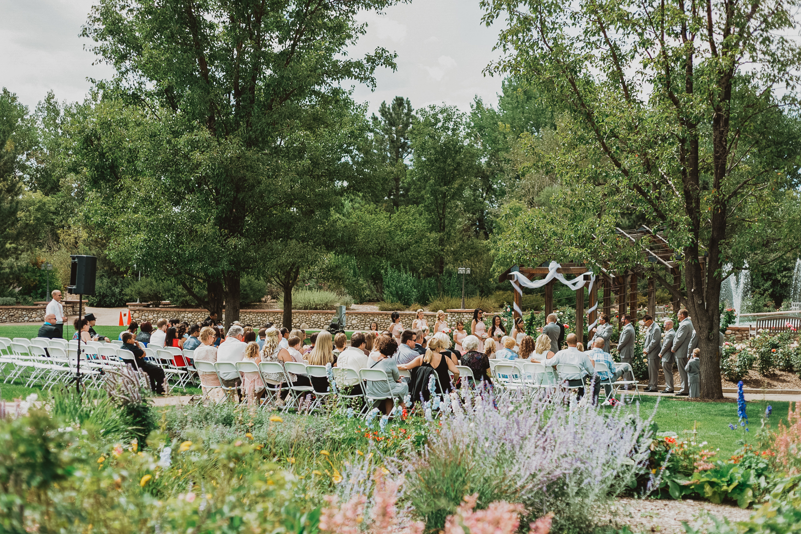 Bride and groom embracing romantically among garden blooms at Hudson Gardens wedding