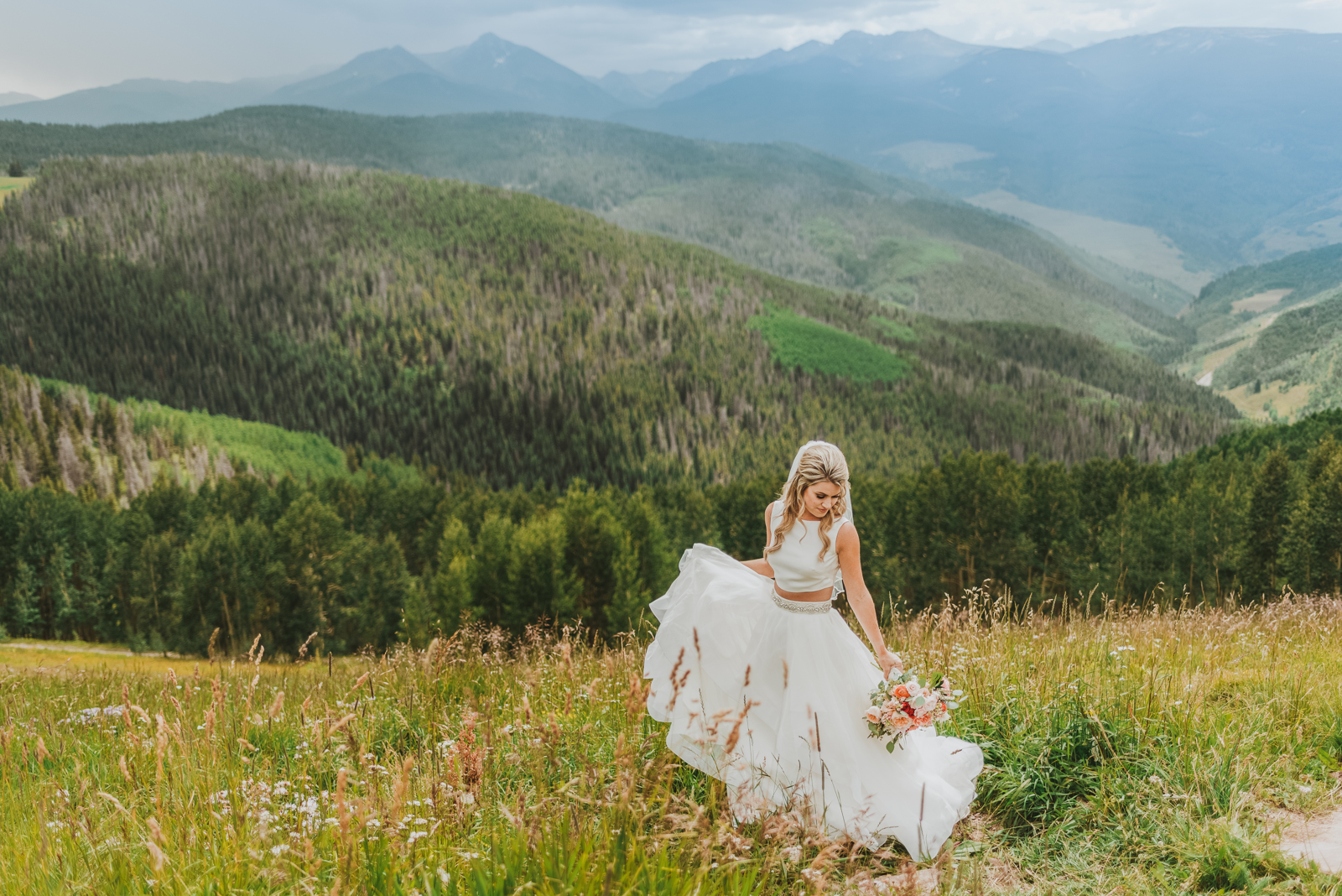 Close-up of bride and groom exchanging vows with blurred mountain backdrop