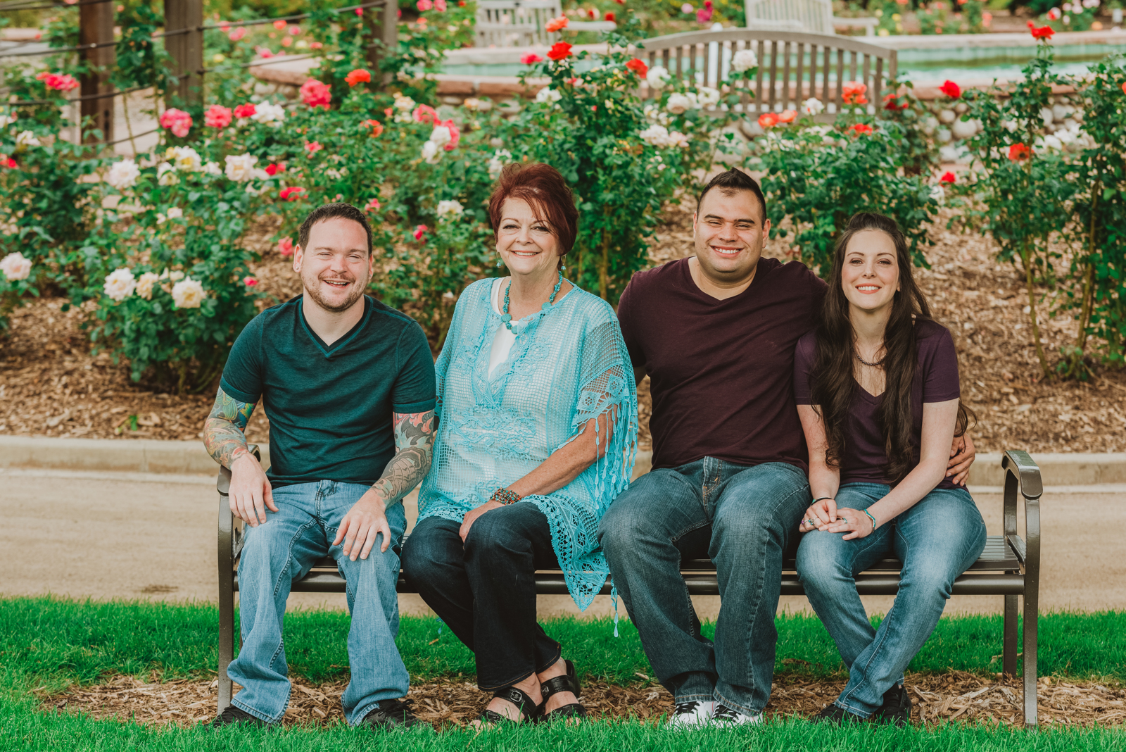 Children playing joyfully among flowering plants with parents watching in Hudson Gardens