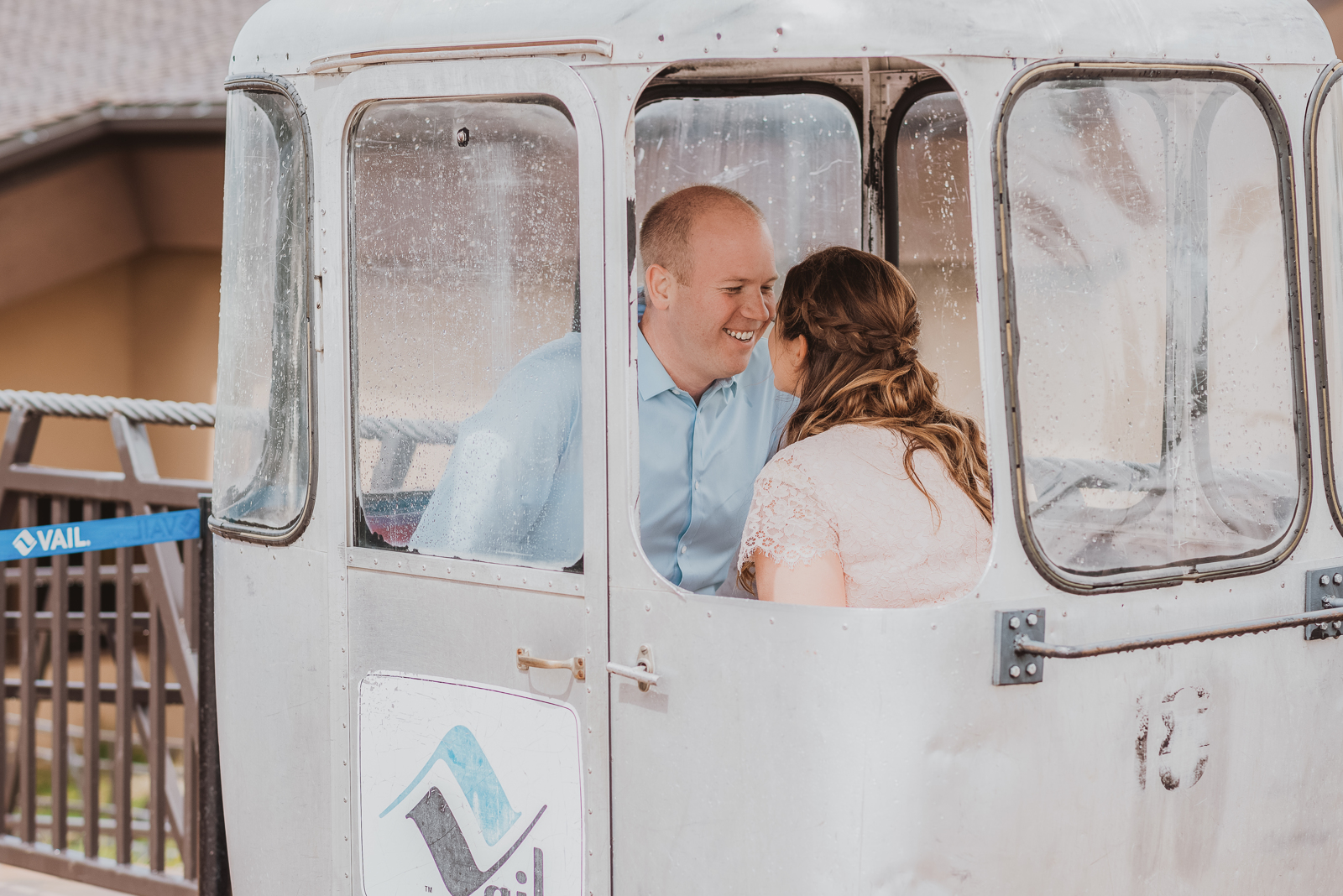 Bride and groom standing on mountain overlook with Gore Range vista in Vail Colorado