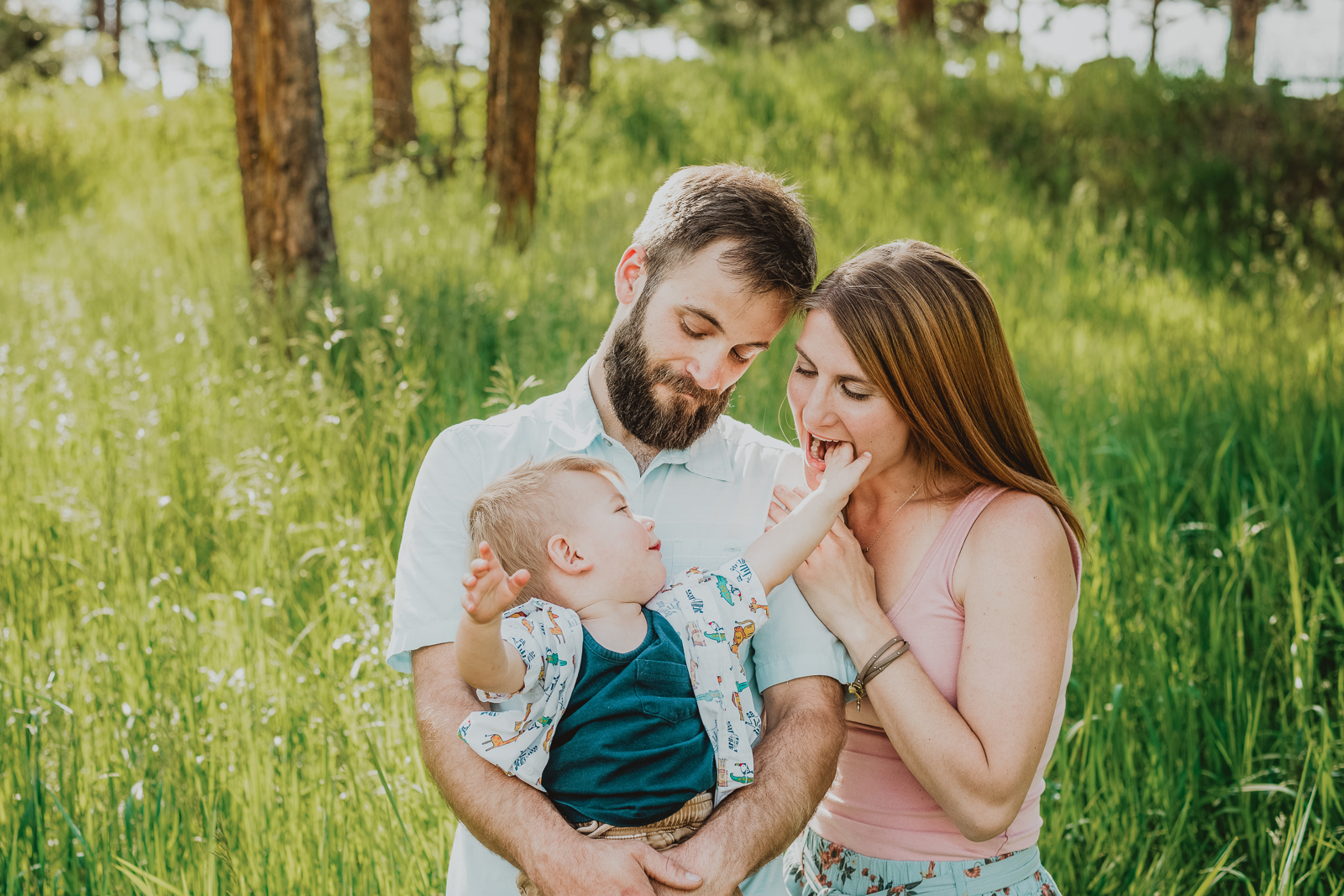 Family with children playing and interacting on grassy overlook area at Lookout Mountain Golden Colorado
