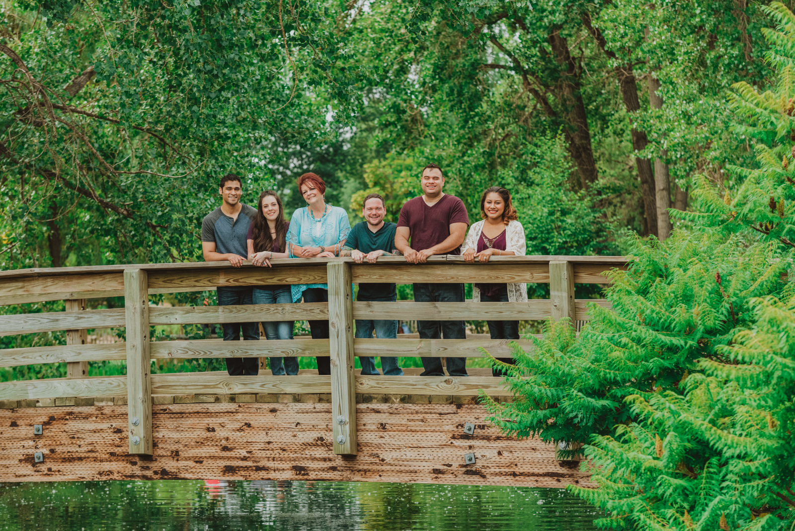 Young family enjoying candid moments among vibrant garden plantings at Hudson Gardens