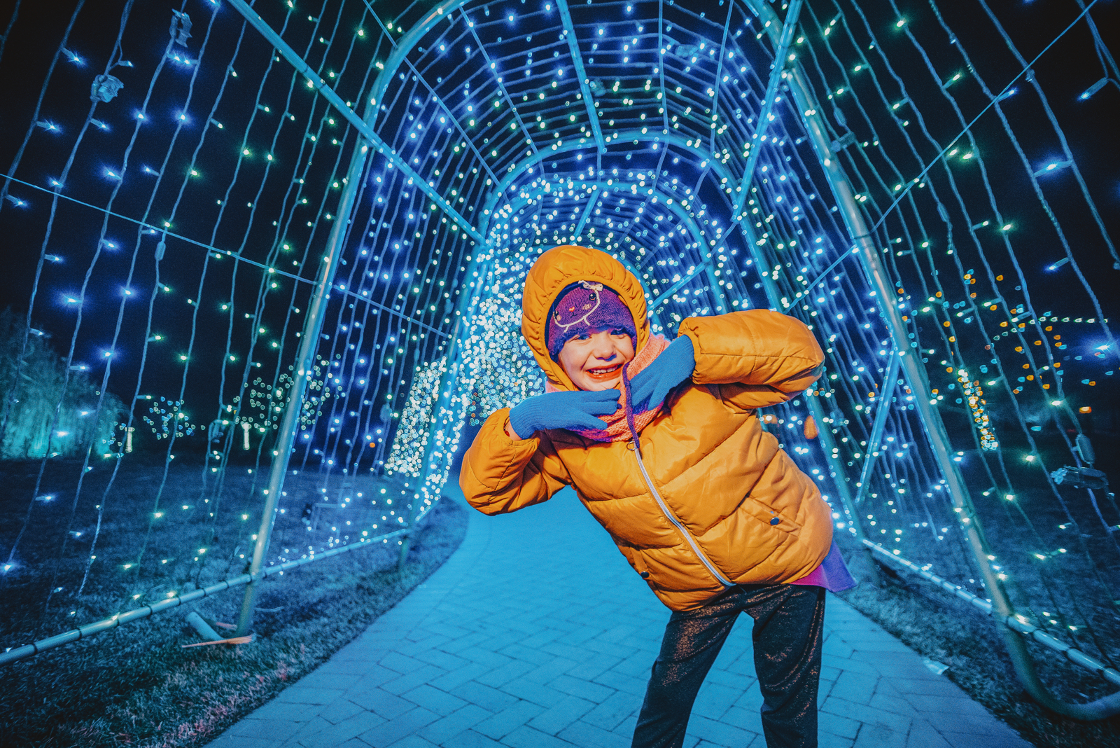 Family smiling together among blooming garden flowers and green landscaping at Hudson Gardens