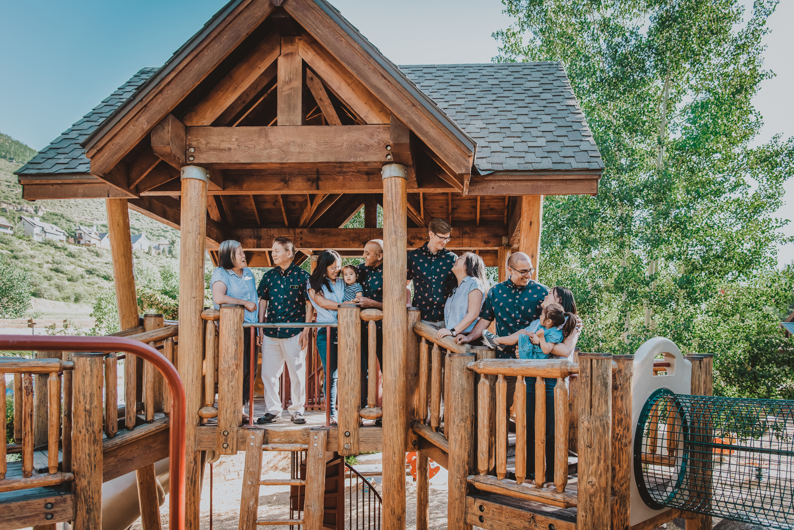 Parents with young children in meadow setting with Vail mountains in background