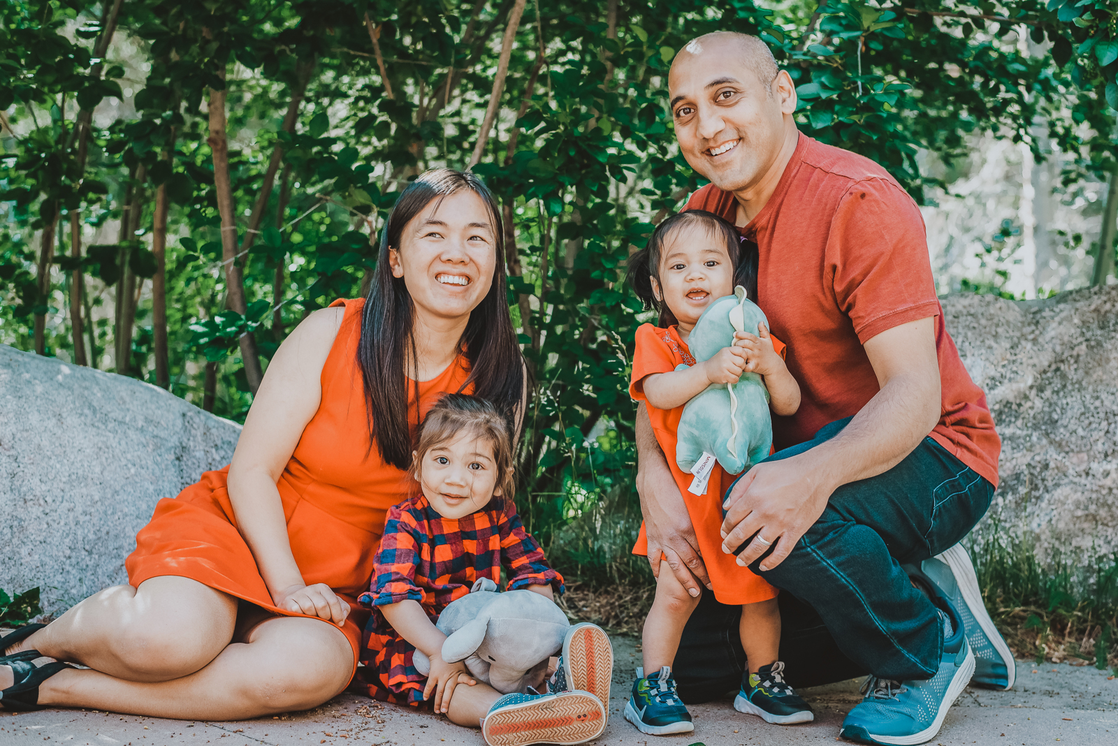 Multi-generational family standing together on mountain overlook with scenic vista backdrop
