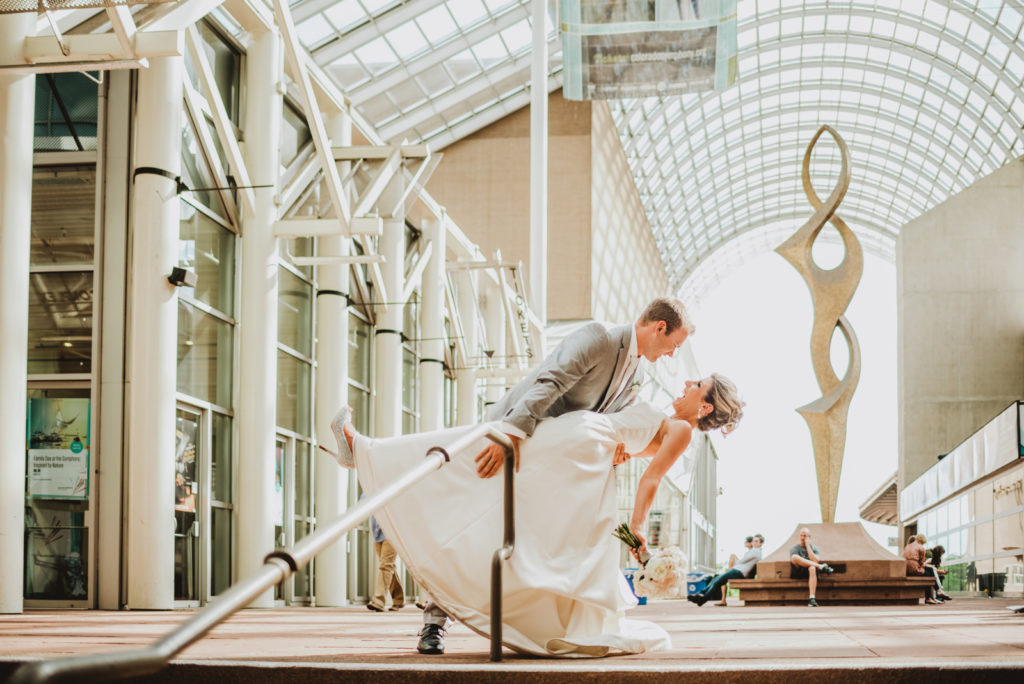 Downtown Denver Dairy Block outdoor urban fun candid loving wedding picture | From the Hip Photo Denver portrait photography 