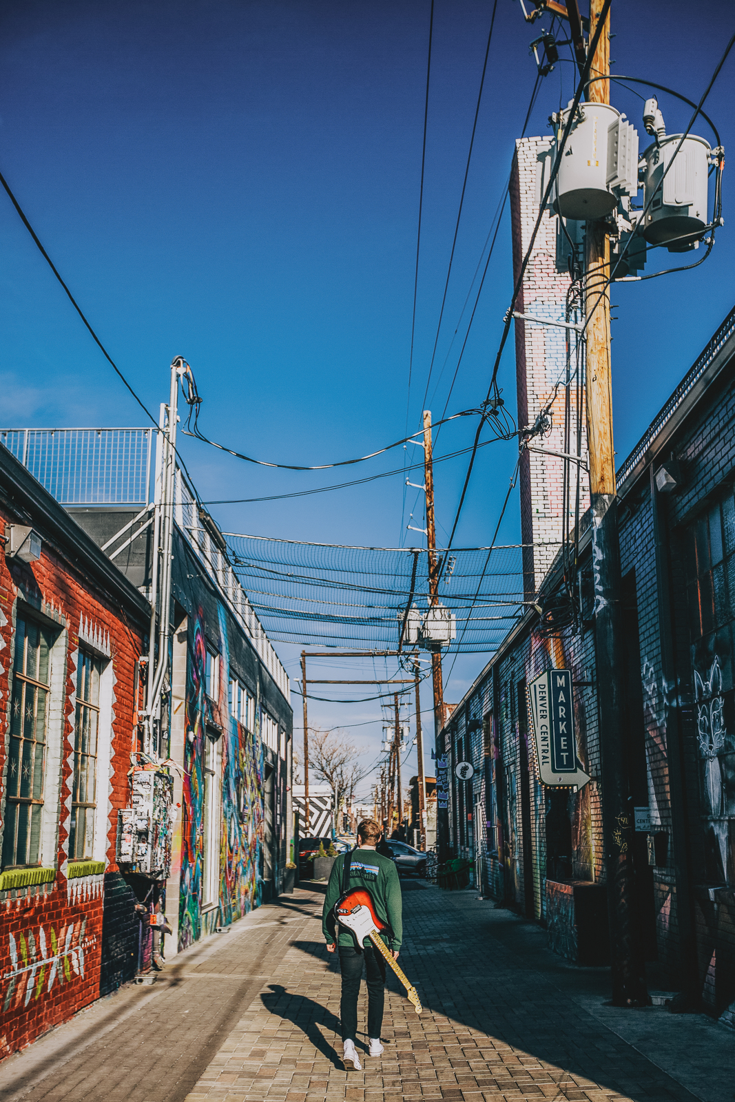 Romantic portrait in Denver River North neighborhood with street art and warm golden light