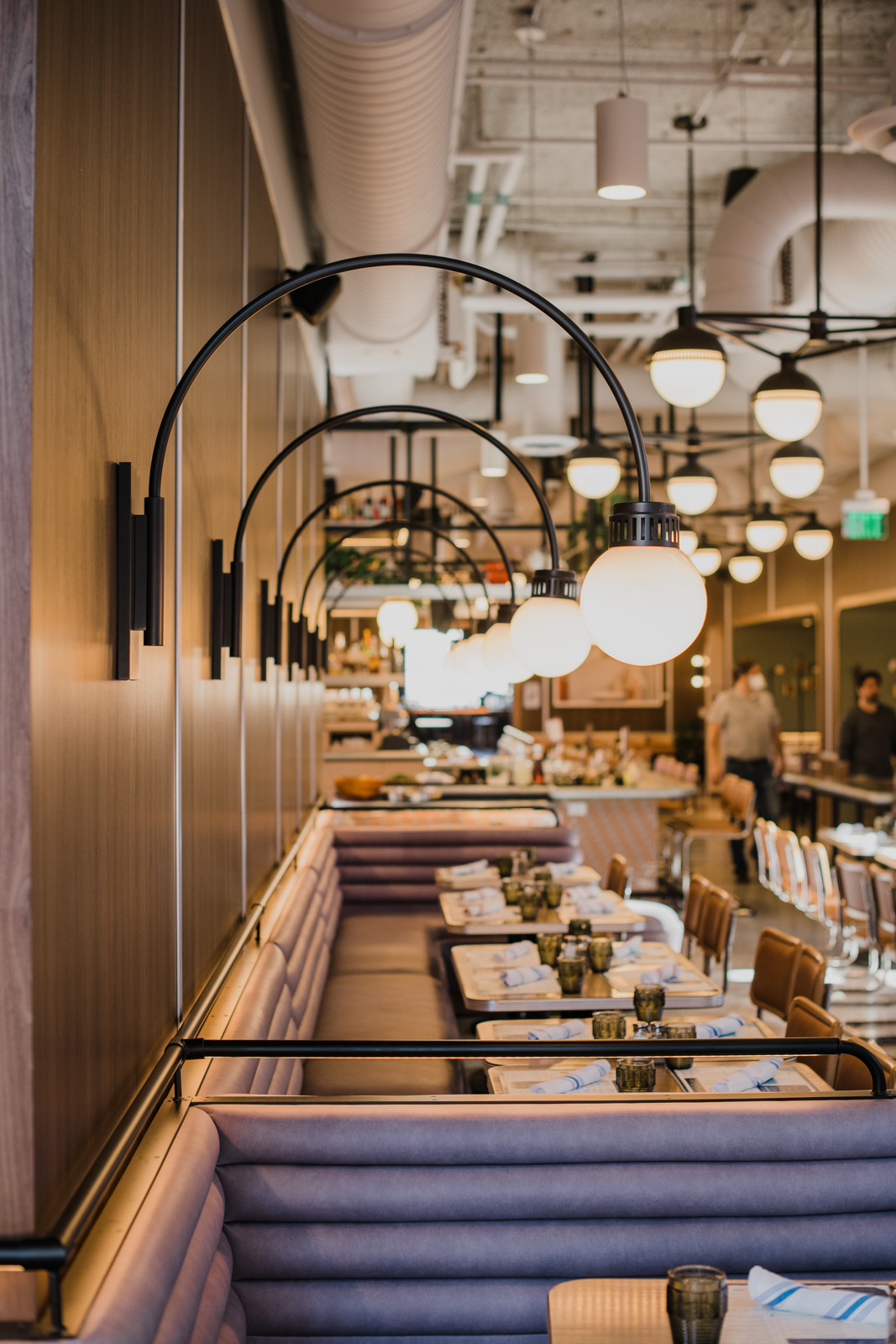 Colorado Hotel & Food Photography | The Original, The Rally Hotel | Shot of arching lamps overlooking row of tables in dining area