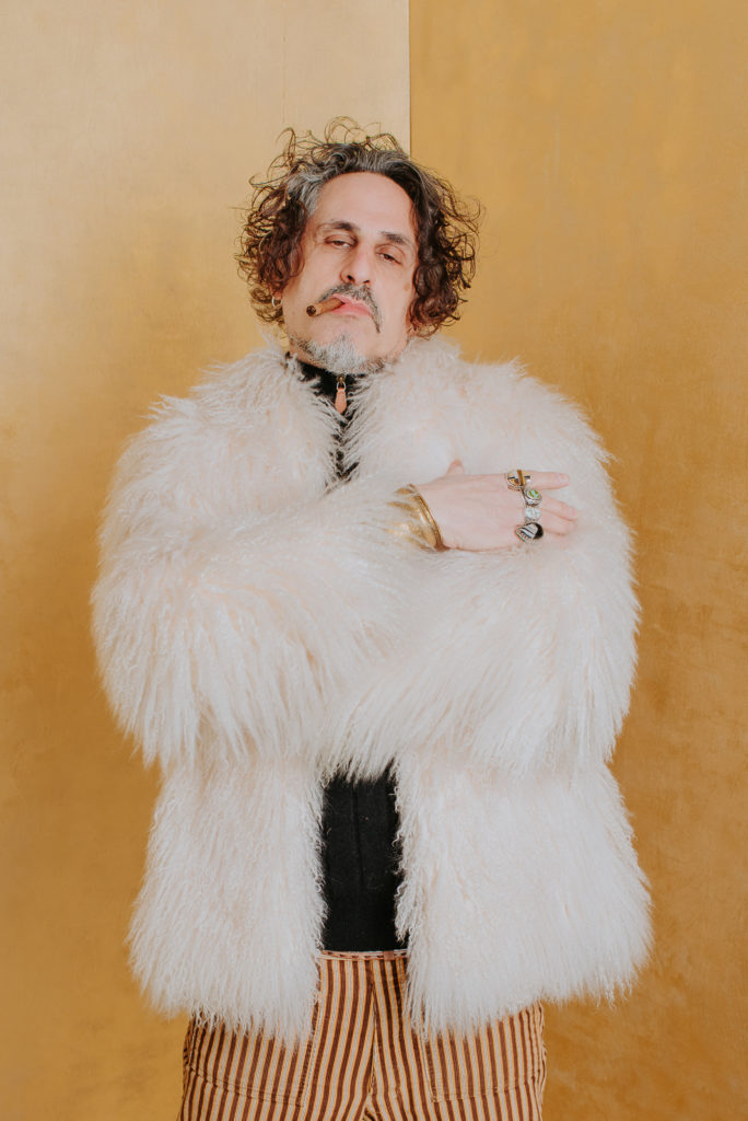 Business Photography | Spy Bar artist poses with white fluffy jacket and cigar | Event Photography | Factory Five Five