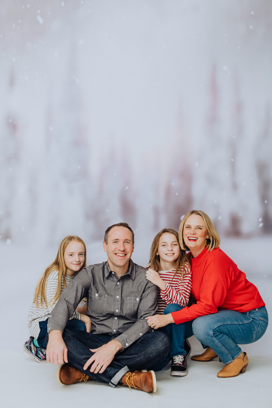 Woman in formal attire smiling beautifully during professional family portrait holiday photo session