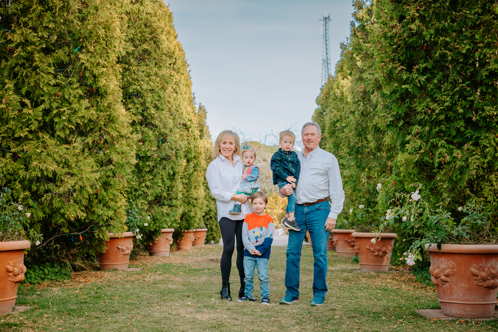 Family walking together through the lush gardens at Denver Botanic Gardens during a portrait session
