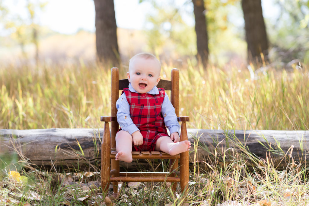 Newborn photography | First year photos in a field with a baby rocking chair