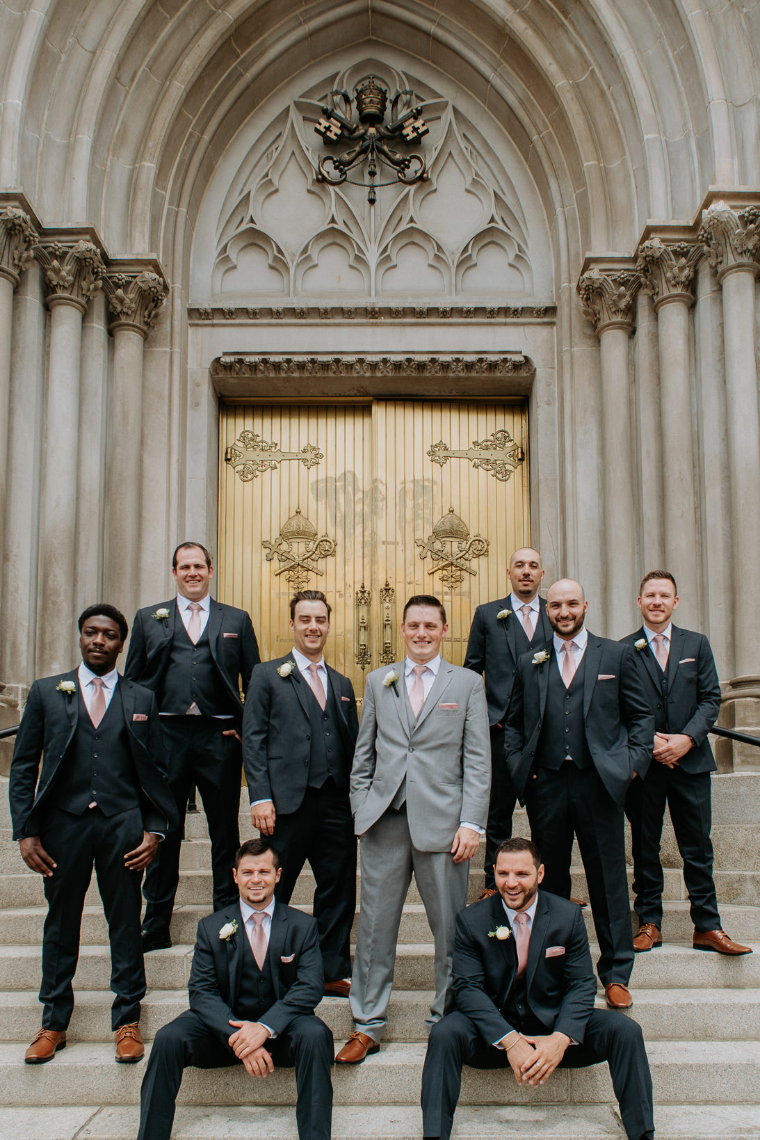 Wedding Photography | Groom poses with groomsmen on staircase | Cathedral Basilica of the Immaculate Conception, Denver