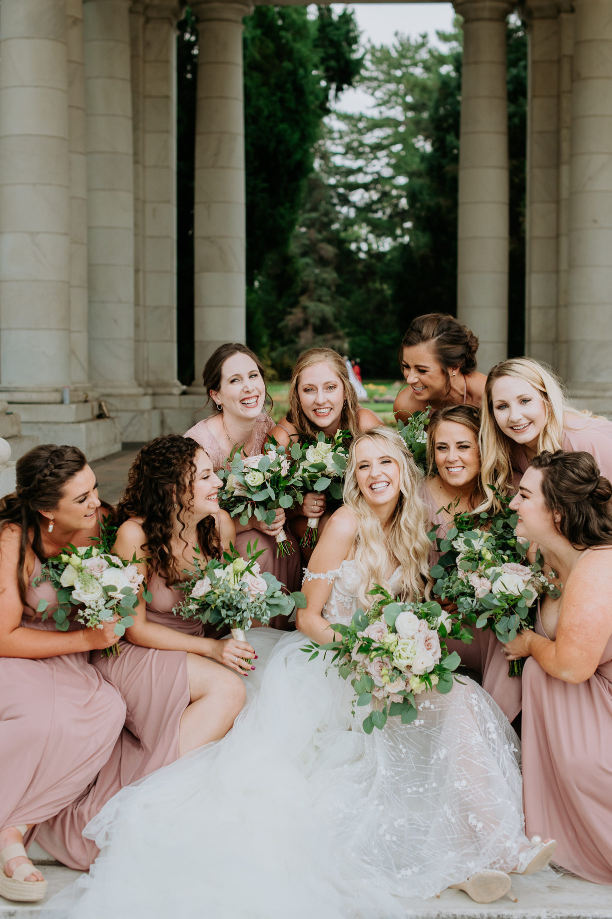 Wedding Photography | Bridesmaids and bride pose on the steps of Cheesman Park. 