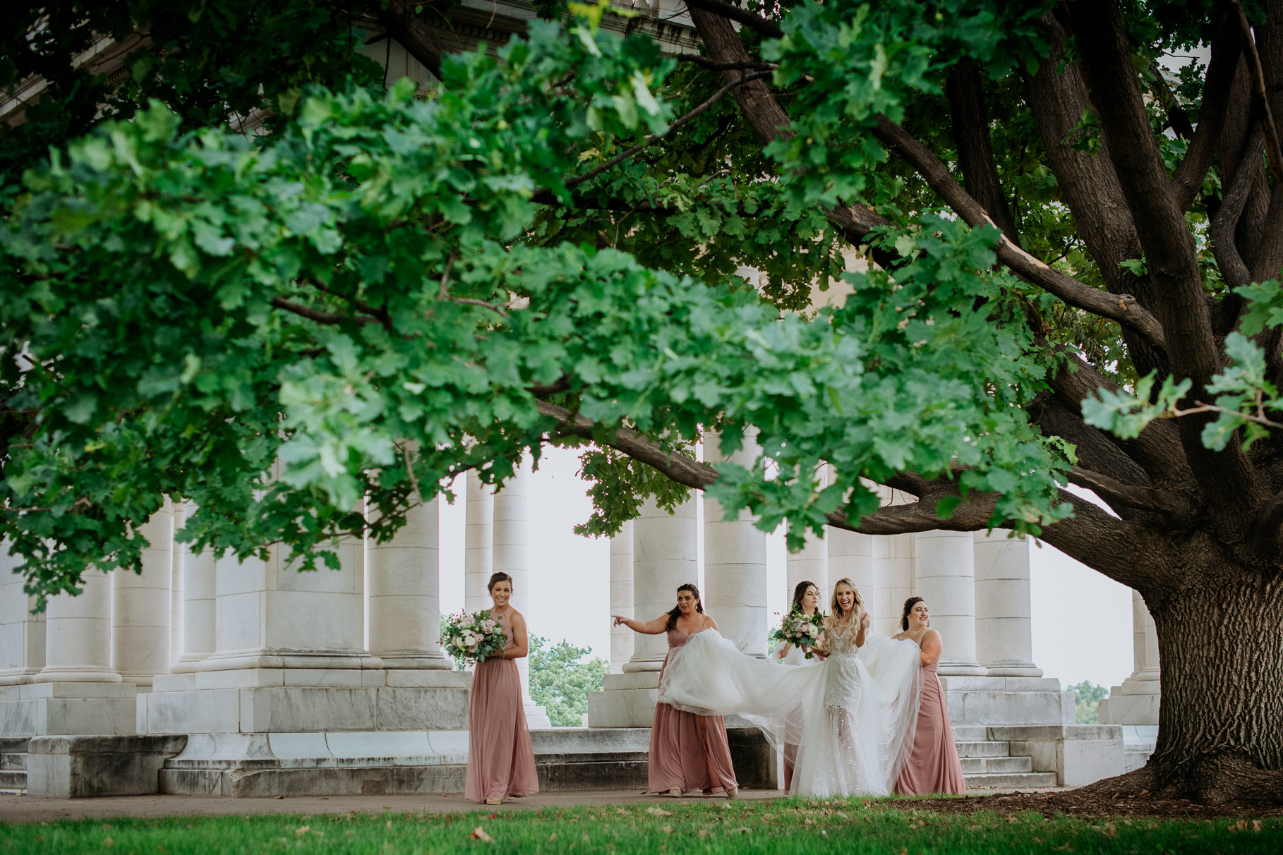 Wedding Photography | Bridesmaids help carry bride's dress train as she walks | Denver Botanical Gardens