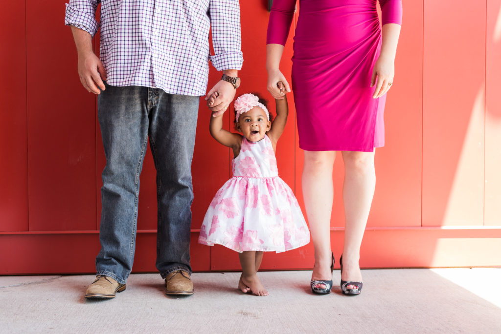 Newborn family photography | Cute baby toddler girl holds her parents hands
