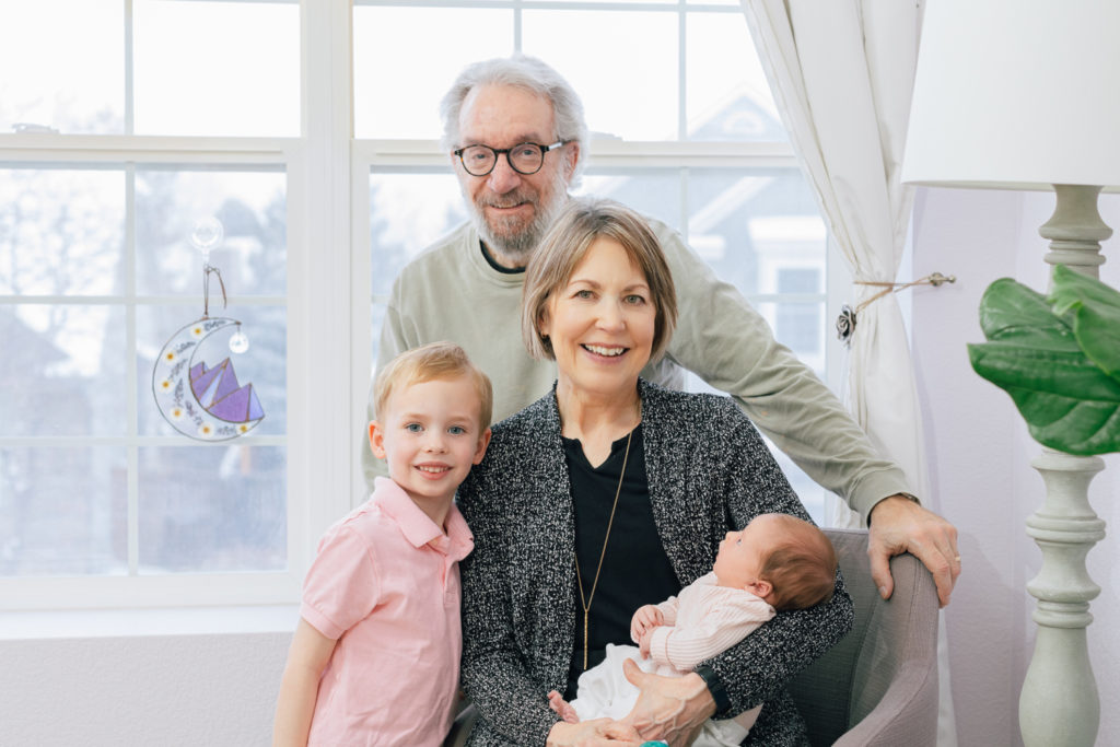 Newborn photography | Grandparents pose with their grandchildren in a living room