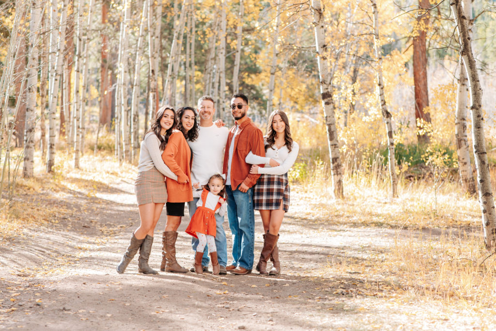 Colorado Fall Family Photo Tips | Aspen grove in autumn with muted colors and a matching orange color coordinated family