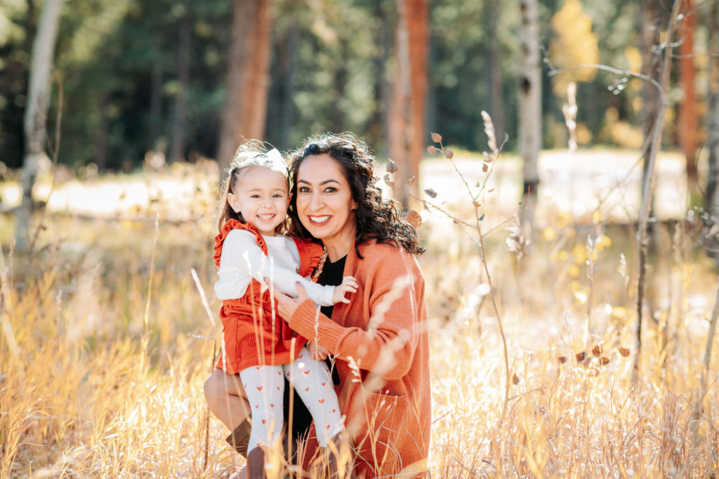 Colorado Fall Family Photo Tips | Mom poses with a kid with a matching coordinated autumn outfit 