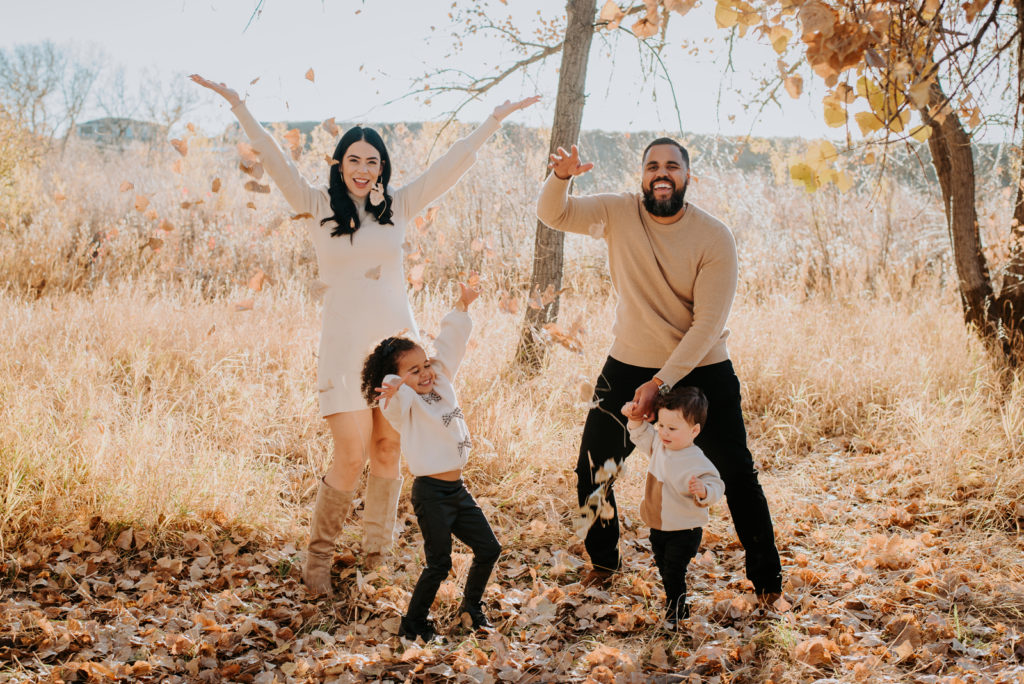 Colorado Fall Family Photo Tips | Family having fun throwing fall leaves