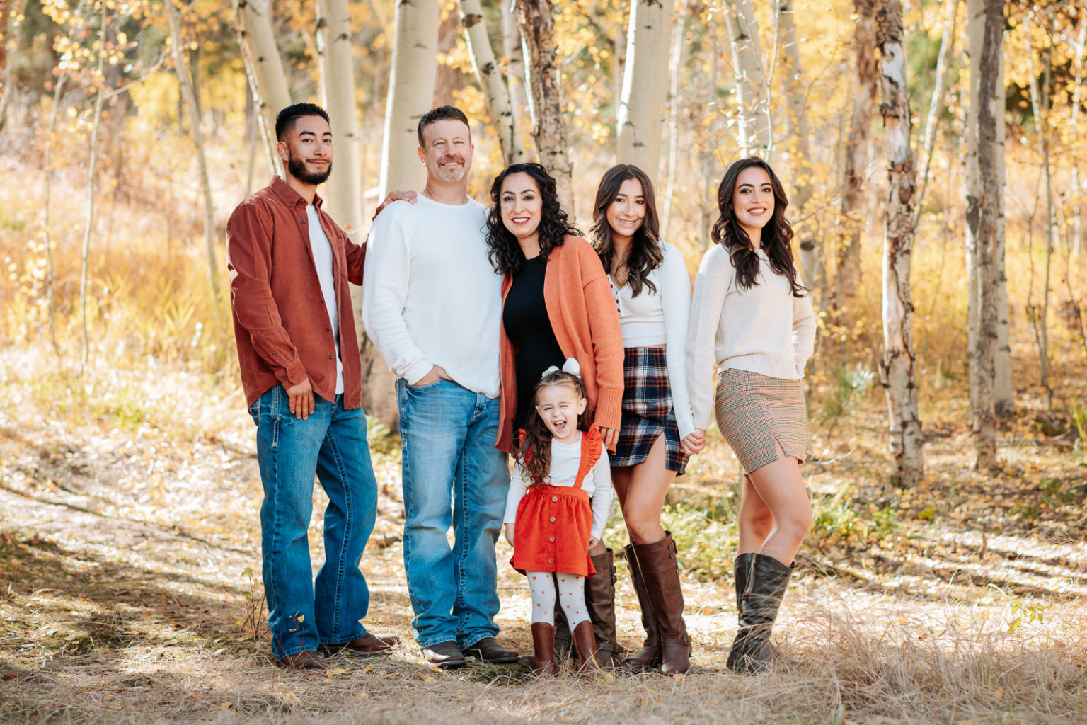 Professional family portrait photography capturing genuine moments and interactions with proper wardrobe planning