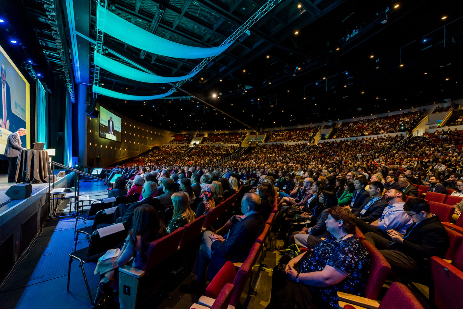 Professional photographer capturing keynote speaker at Colorado Convention Center